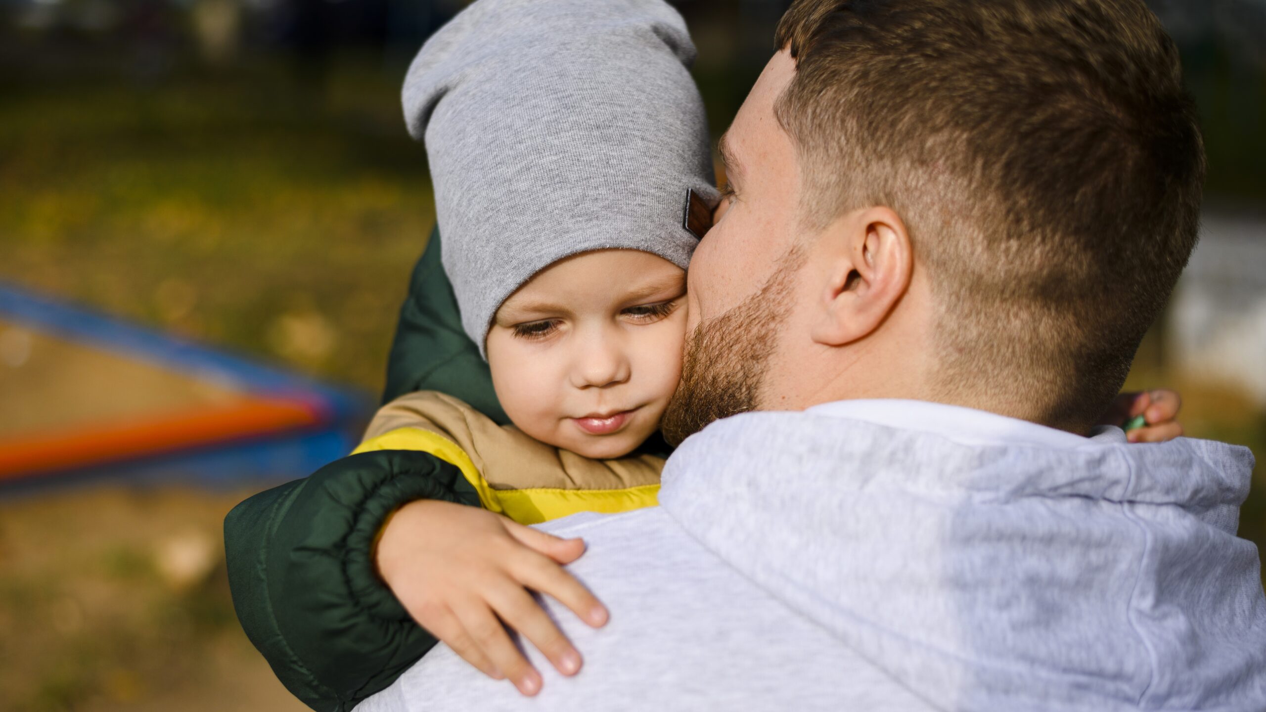 young-man-holding-boy-his-arms
