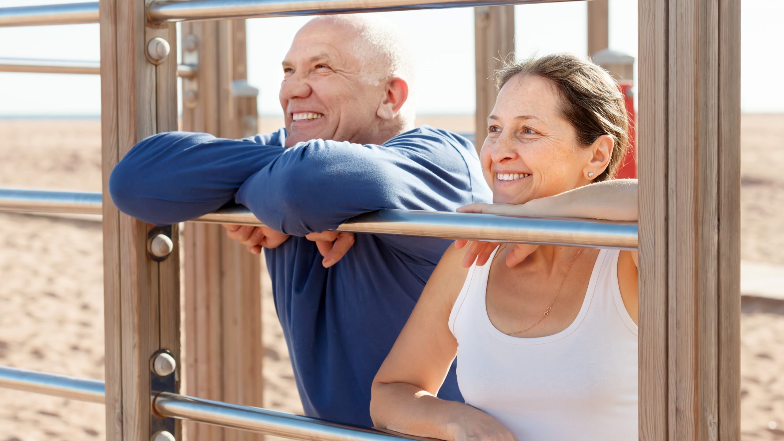 mature couple together near sports equipment