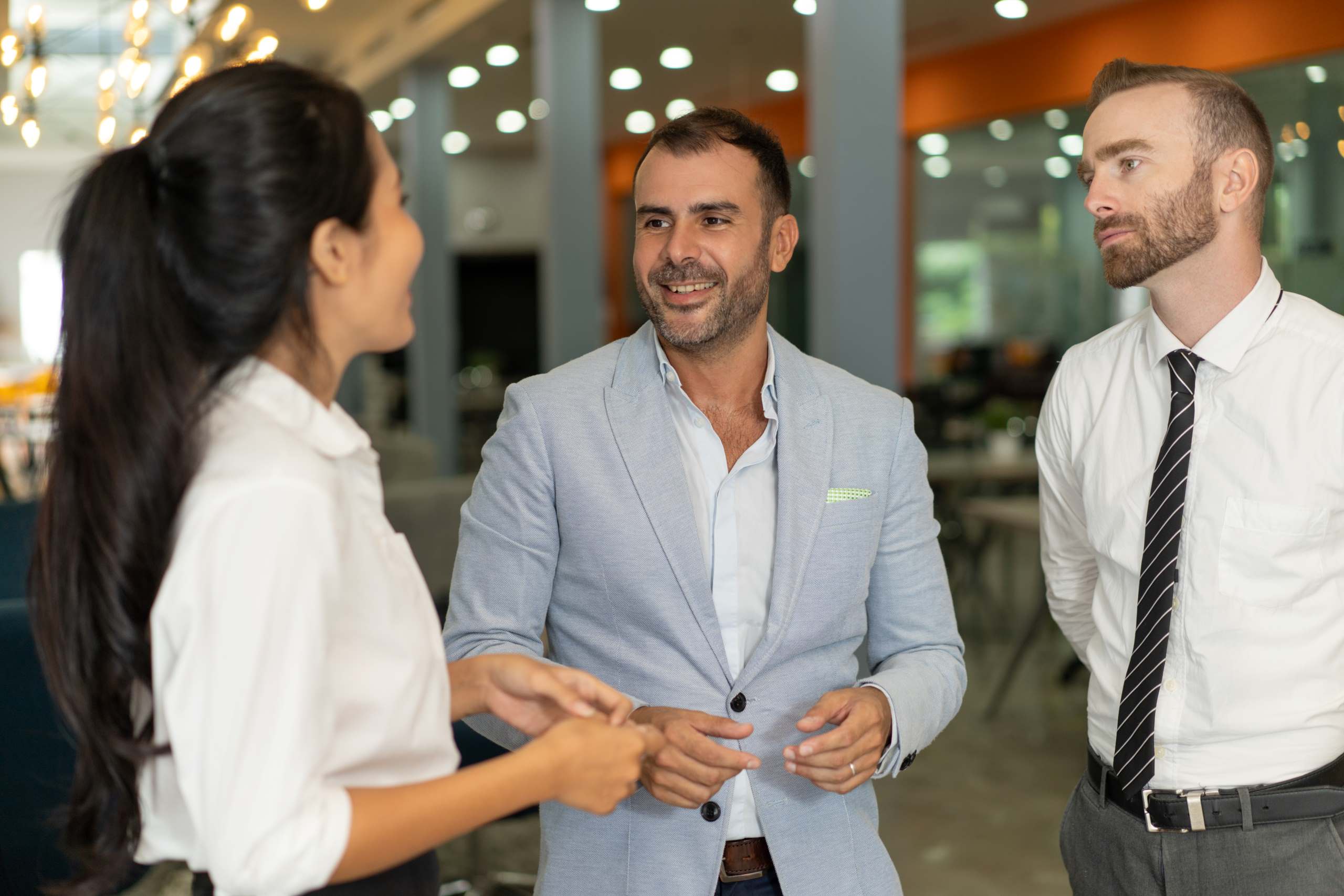 three-positive-business-people-chatting-office