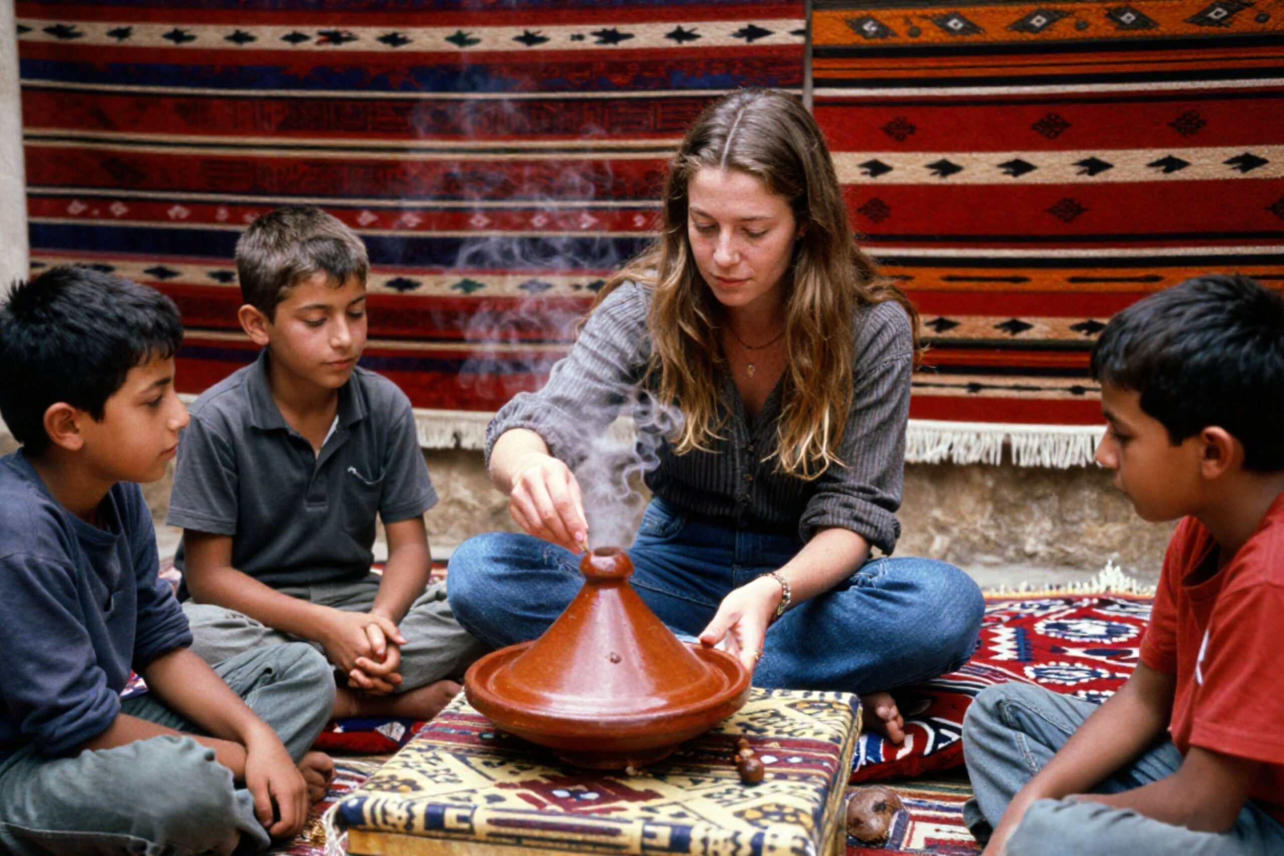 Amazigh Hospitality - young belgian woman sharing tagine with young Amazigh boys