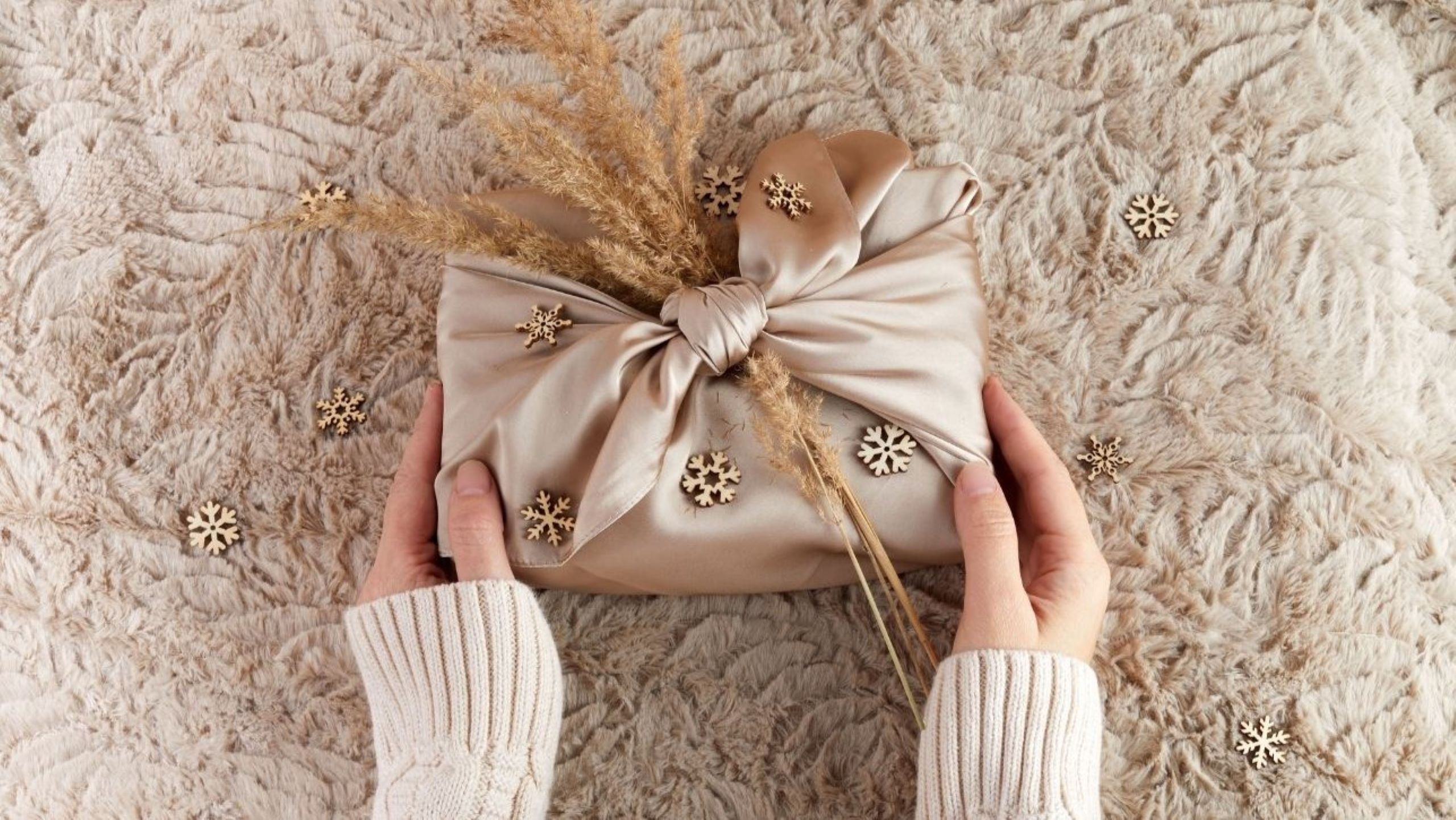Beautiful eco-friendly gift wrapping using traditional Moroccan handira textile with geometric patterns and sequins, demonstrating sustainable Furoshiki technique replacing wasteful paper with reusable artisan fabrics