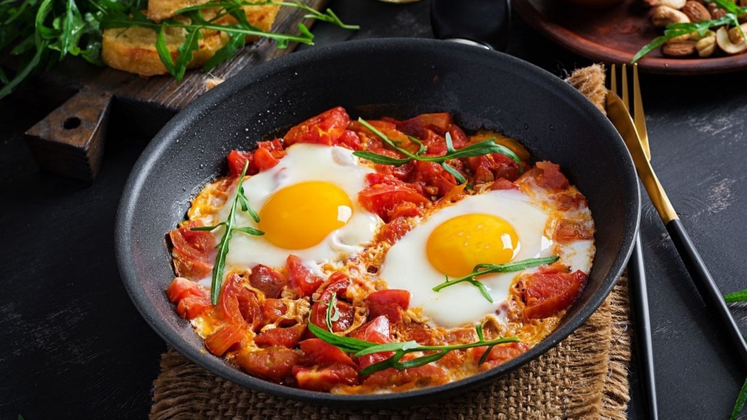 Traditional Moroccan shakshuka with poached eggs in spiced tomato sauce served in tagine, representing healthy naturally gluten-free breakfast option perfect for health-conscious diners