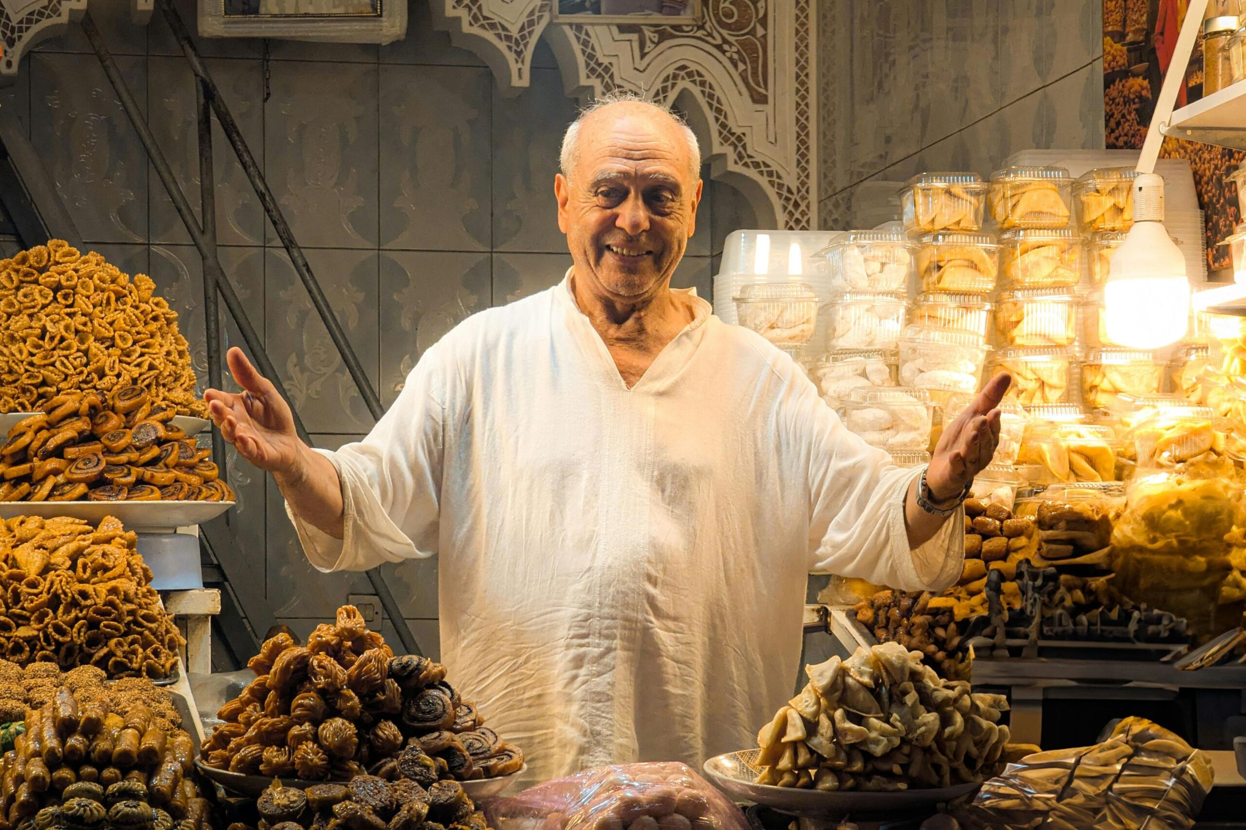 Souk negotiation Moroccan merchant smiling customer market stall
