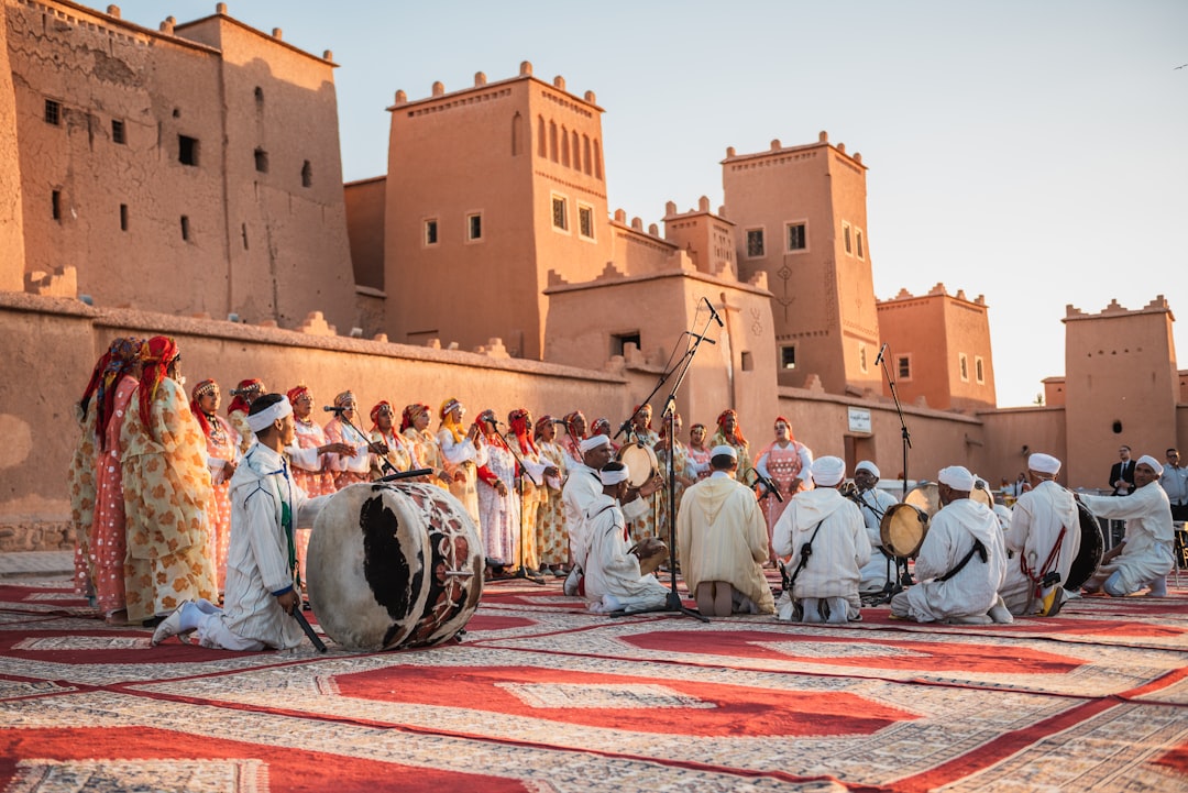 Performers and visitors fill a Moroccan medina square during a June Morocco music festival celebration.