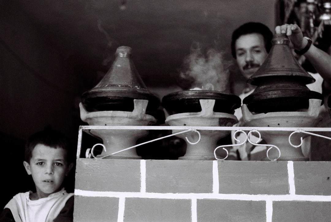 A family with children learning to cook in a traditional riad kitchen, one of the most popular Marrakech activities for kids