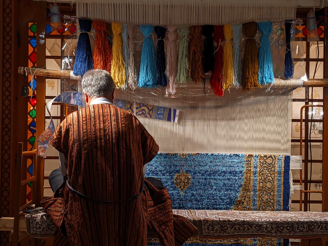 A craftsperson hand-weaves natural cotton cloth in a Moroccan workshop, a cornerstone of sustainable fashion in Morocco