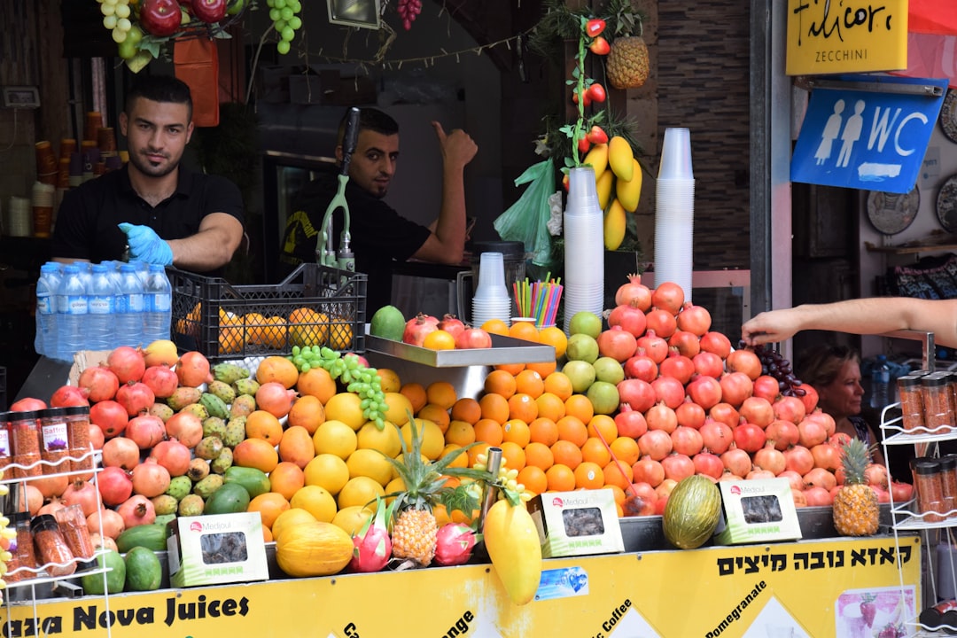 A woman enjoying a freshly squeezed orange juice at a Moroccan street food stand on a hot summer afternoon