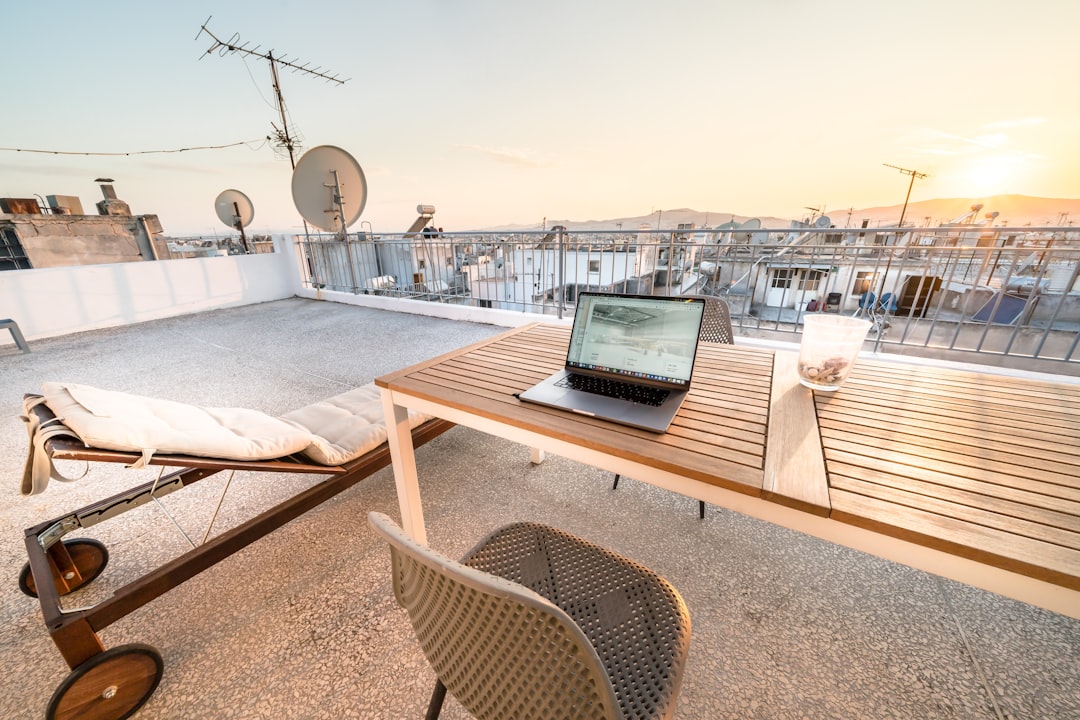 A remote worker on a rooftop in Essaouira with Atlantic coast views, representing Morocco's growing nomad and startup scene