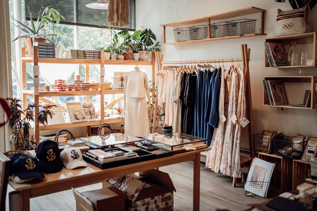 A woman exploring a boutique of ethically made Moroccan fashion, surrounded by natural-fabric summer garments.