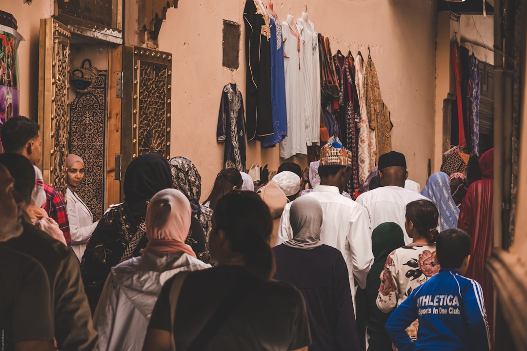 walking through the ancient medina of Fes during the Morocco festival season, lanterns lighting the narrow stone alley