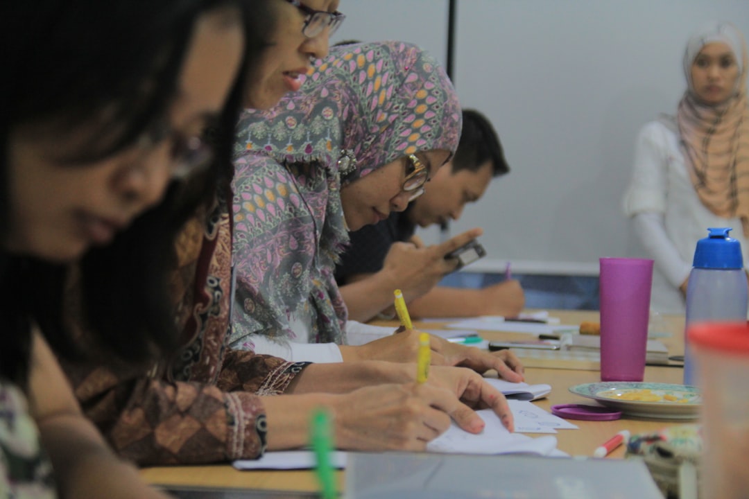 A student practices Moroccan calligraphy with ink and a traditional pen at a workshop in Fez