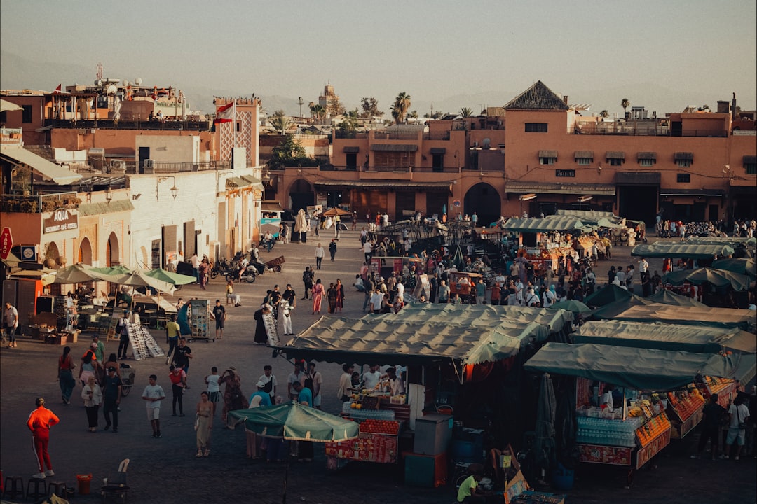 A family explores a colorful souk together on a Morocco holiday, discovering artisan crafts in the historic medina