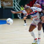 A Moroccan handball player celebrates during an African handball championship match in front of a passionate crowd