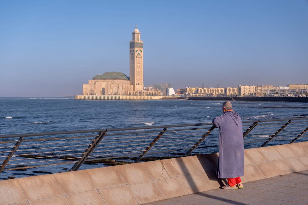 A professional woman working at a seafront café where Atlantic winds keep the air cool along Morocco's coast