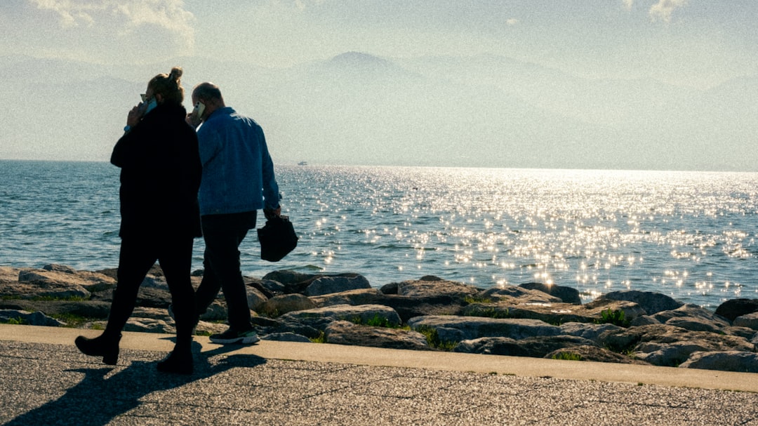 people walk along the Casablanca waterfront, where Atlantic winds moderate coastal temperatures year-round in Morocco