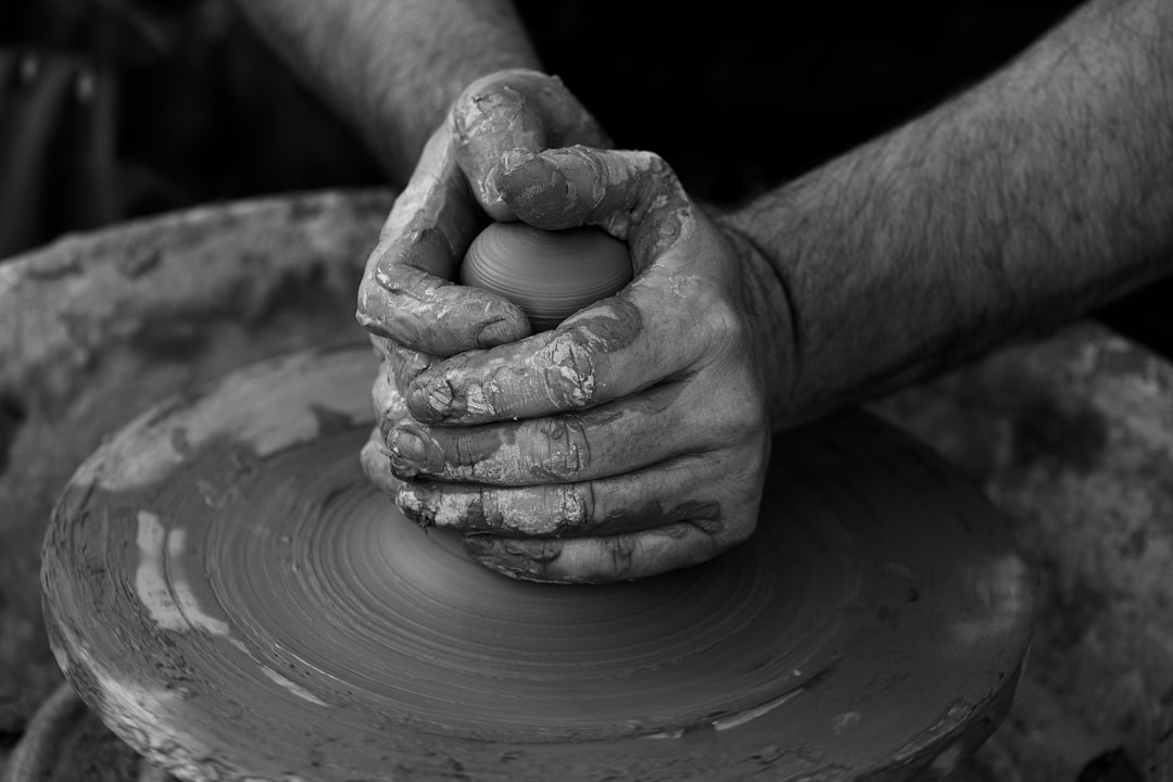 Artisan arranging traditional Moroccan food pottery at a market stall