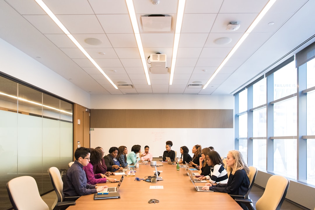 Finance professionals discuss wealth management strategy during a boardroom meeting at an African financial hub