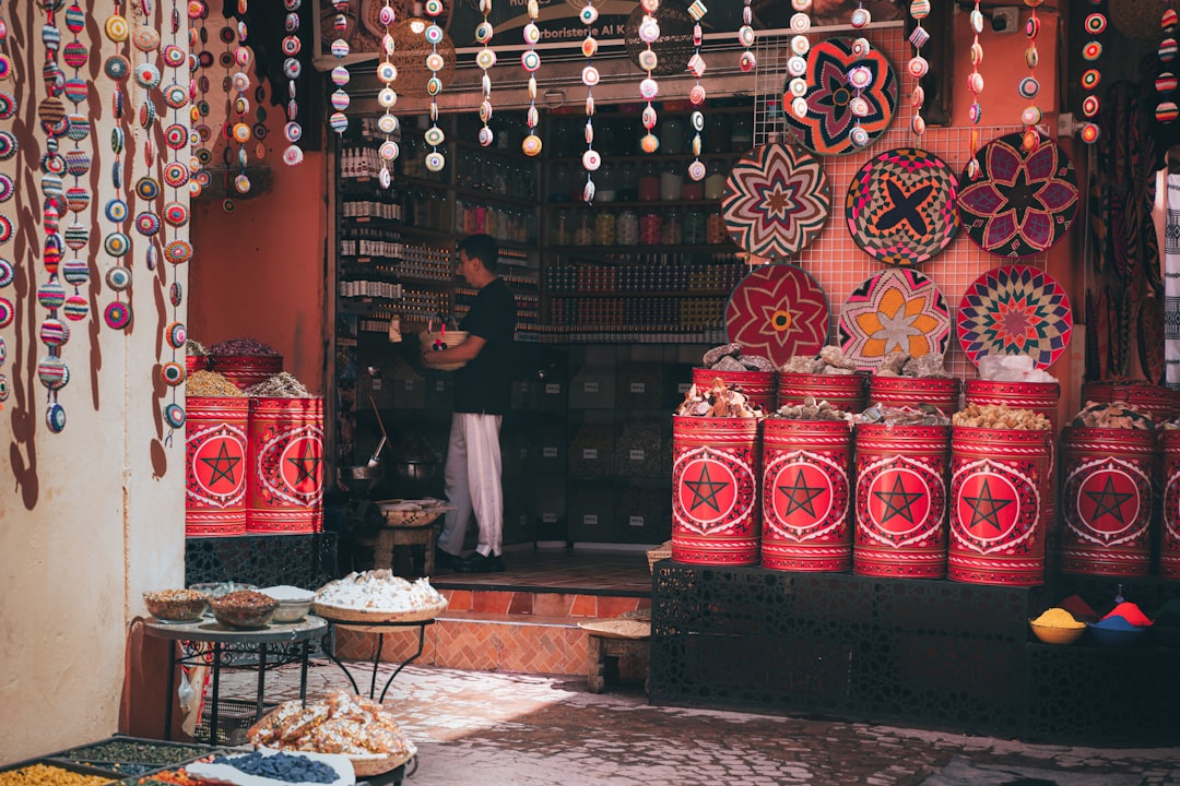 A member of a women cooperative displays medicinal plant products at an outdoor rural market in Morocco