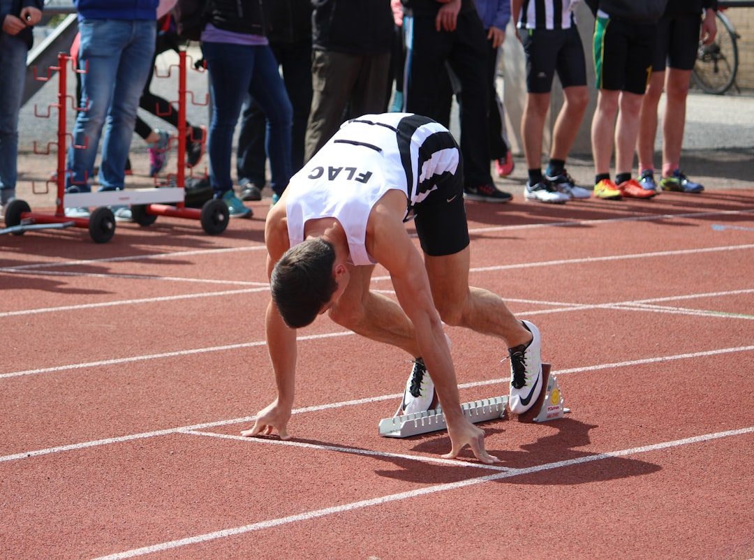 A runner training at a Moroccan athletics club track during a morning session