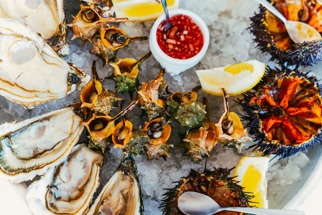A visitor enjoys fresh oysters at a lagoon-side café, a highlight of the coastal medinas north of Agadir