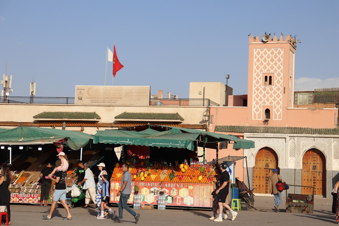 A woman selecting fresh fruit at a colorful Moroccan market, a safe and simple gluten free choice at any Morocco festival