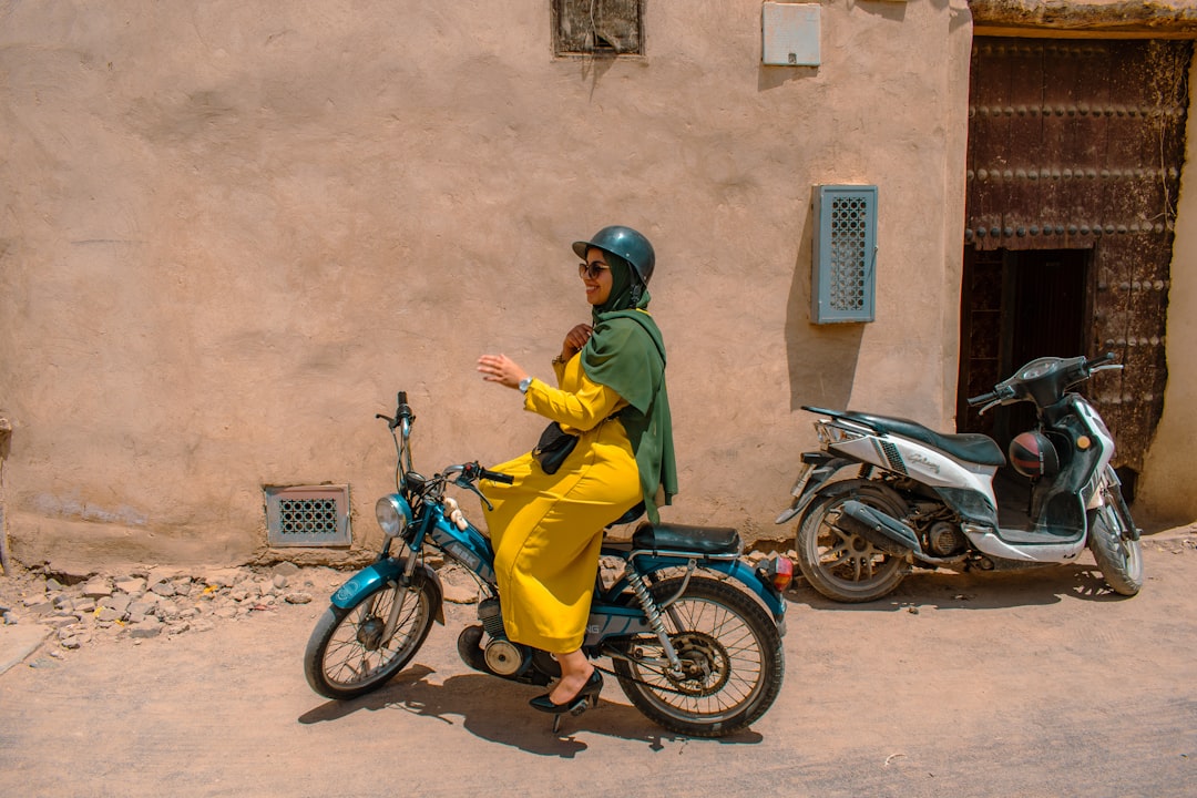 A woman browsing colorful goods in a Marrakech souk during her journey through Morocco's imperial cities
