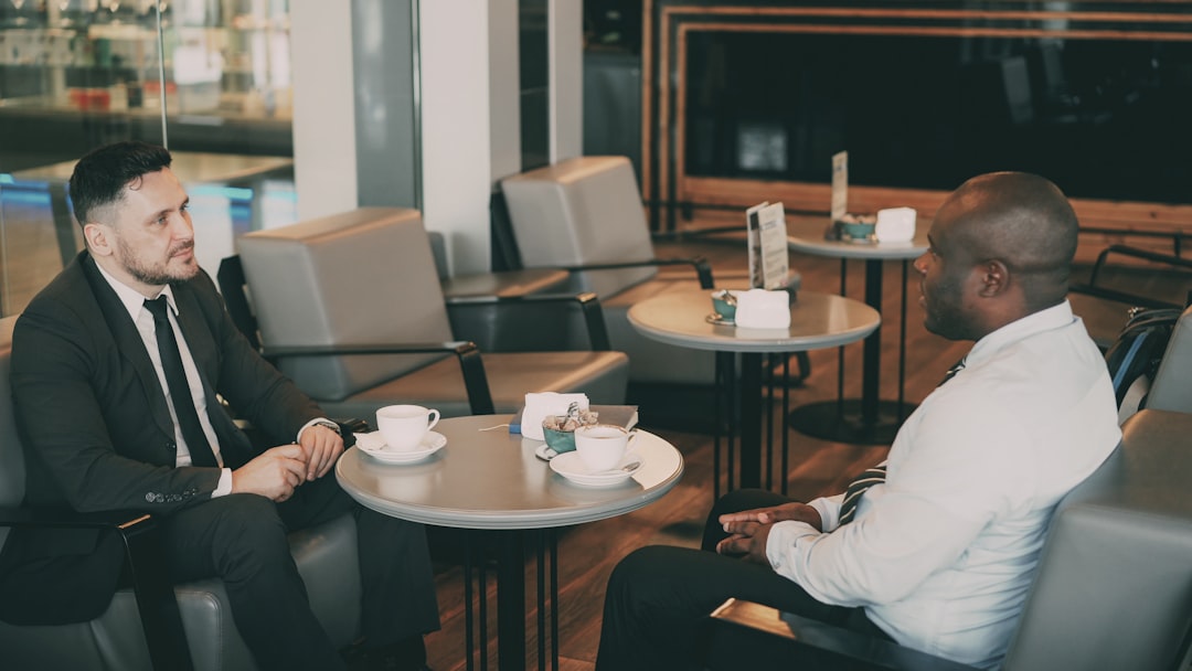 Two entrepreneurs discuss a Morocco trade agreement across a conference table in Casablanca