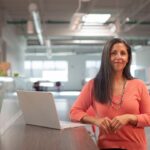 A female founder reviews documents at her desk while registering her startup in Morocco's free zones