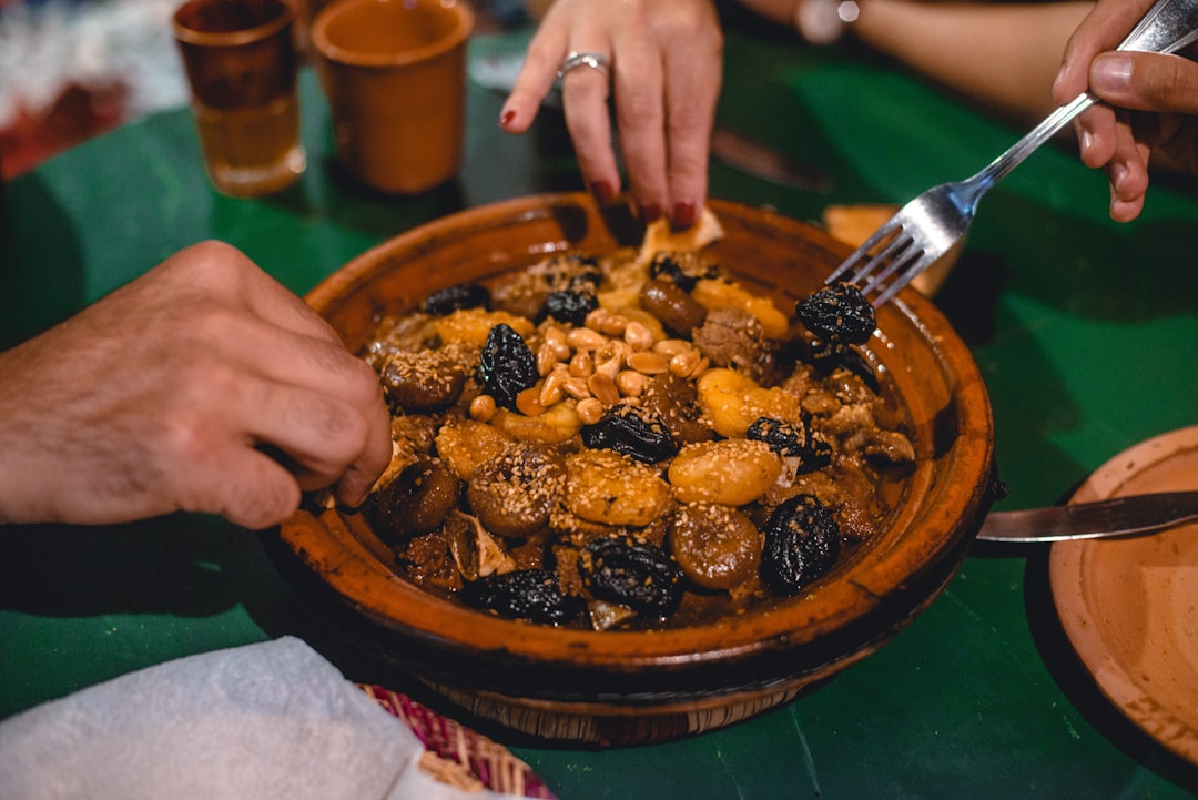 A chef presenting an elegantly plated dish, showcasing how modern kitchens honour classic Moroccan food traditions.