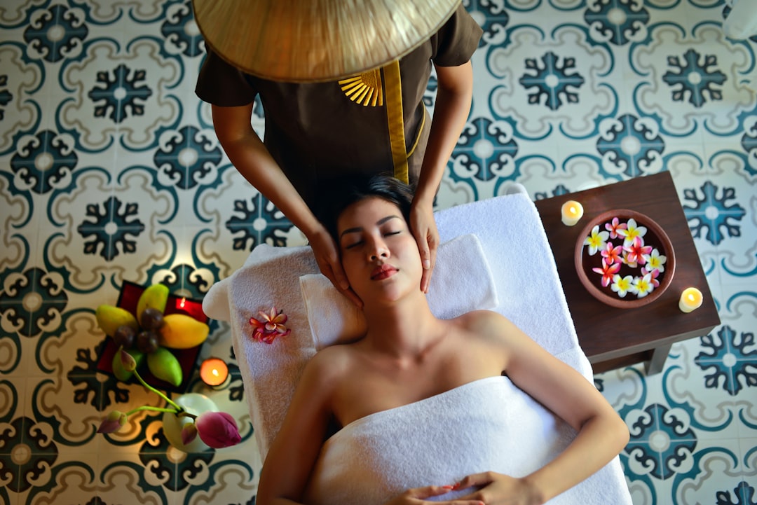 A woman receiving a traditional hammam reset treatment with black soap and a kessa glove in a Moroccan bathhouse