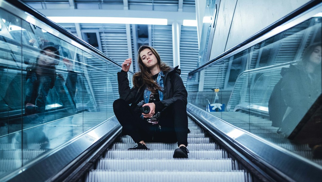 Businesswoman using breathing techniques in a stairwell between meetings