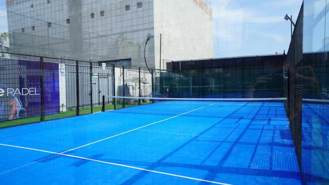 A receptionist processes a padel club membership sign-up in Rabat