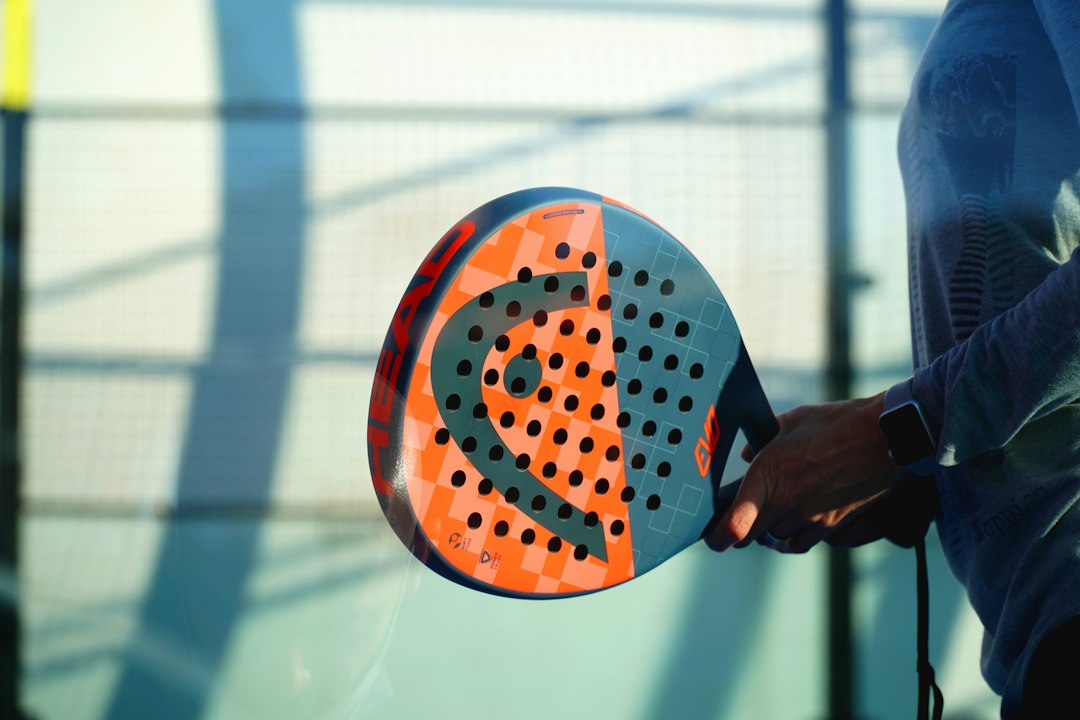 A coach reviews padel club pricing with a student in Marrakech